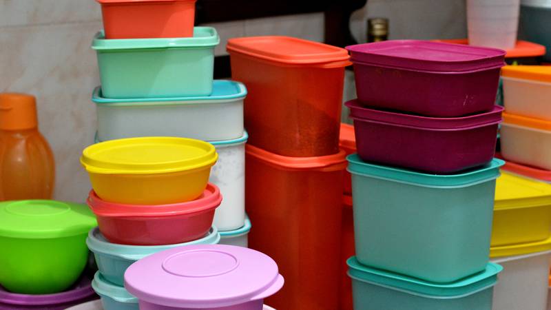 pile of several and many Tupperware plastic products, Tupperware Corporation, an American multinational company produces plastic food storage containers and bottles