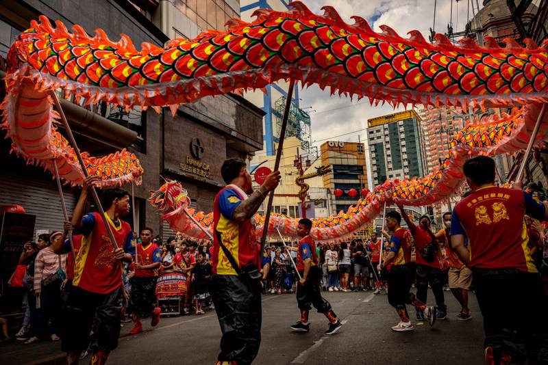 MANILA, PHILIPPINES - FEBRUARY 10: Dragon dancers perform during Lunar New Year celebrations at Binondo district, considered the world's oldest Chinatown, on February 10, 2024 in Manila, Philippines. Lunar New Year, also known as Chinese New Year, is celebrated around the world, and the year of the Wood Dragon in 2024 is associated with growth, progress, and abundance, as wood represents vitality and creativity, while the dragon symbolizes success, intelligence, and honor.  (Photo by Ezra Acayan/Getty Images)