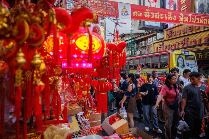 BANGKOK, THAILAND - FEBRUARY 09: Customers shop for Lunar New Year themed items in Chinatown on February 09, 2024 in Bangkok, Thailand. The Chinese diaspora of Southeast Asia celebrates a lively Lunar New Year in Bangkok's Chinatown. It is traditionally a time for people to meet their relatives and take part in celebrations with families. In Thailand, which has a sizeable population of Chinese lineage, people gather with family and celebrate with feasts and visits to temples. The Tourism Authority of Thailand is expecting a steep increase in tourism during the Lunar New Year now that visa free travel is permmited for Chinese citizens to Thailand. (Photo by Lauren DeCicca/Getty Images)