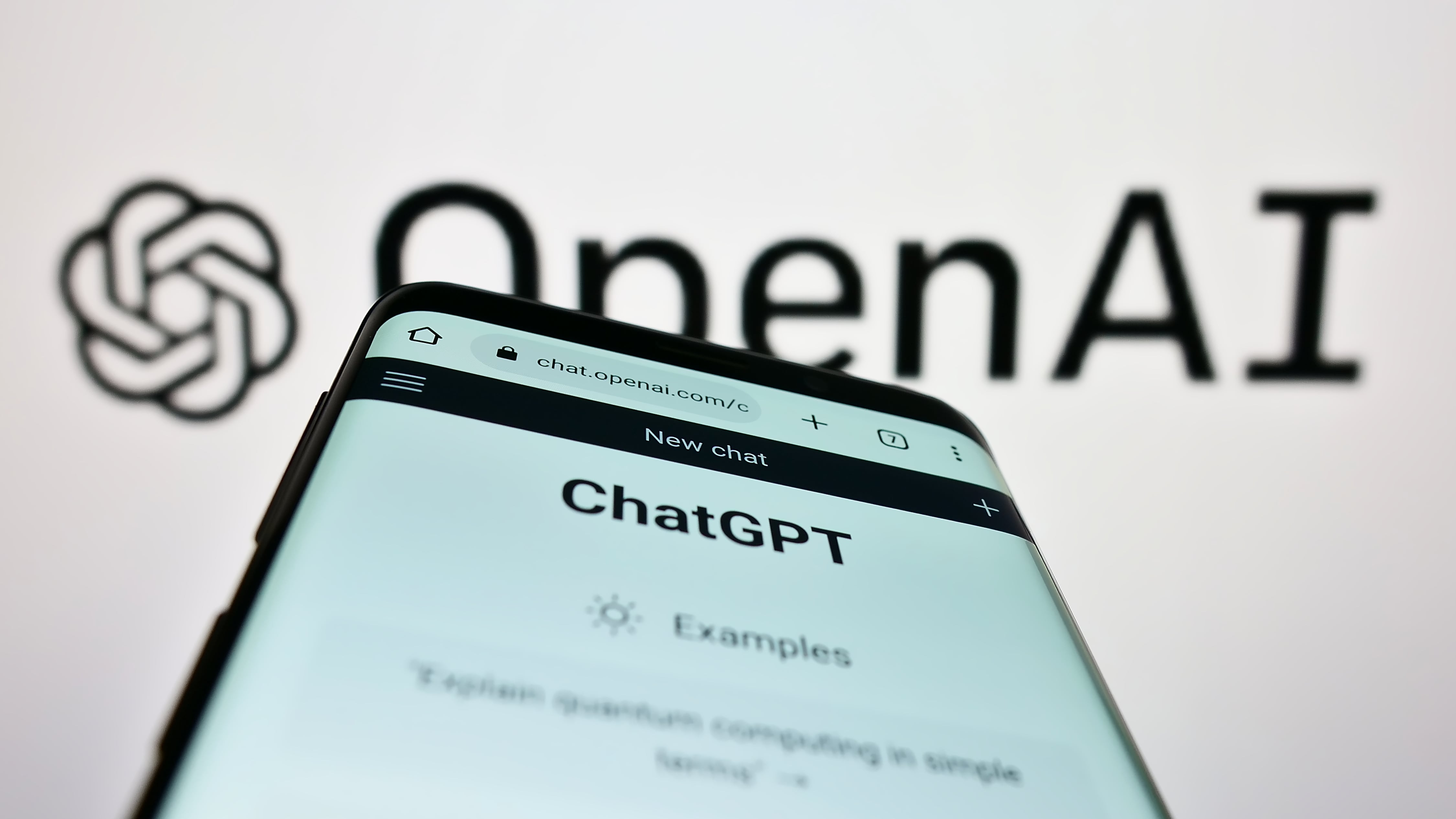 OpenAI logo and ChatGPT on a cell phone