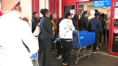 Families finished Thanksgiving dinner and stood in the cold waiting on the doors to open before sunset Thursday.